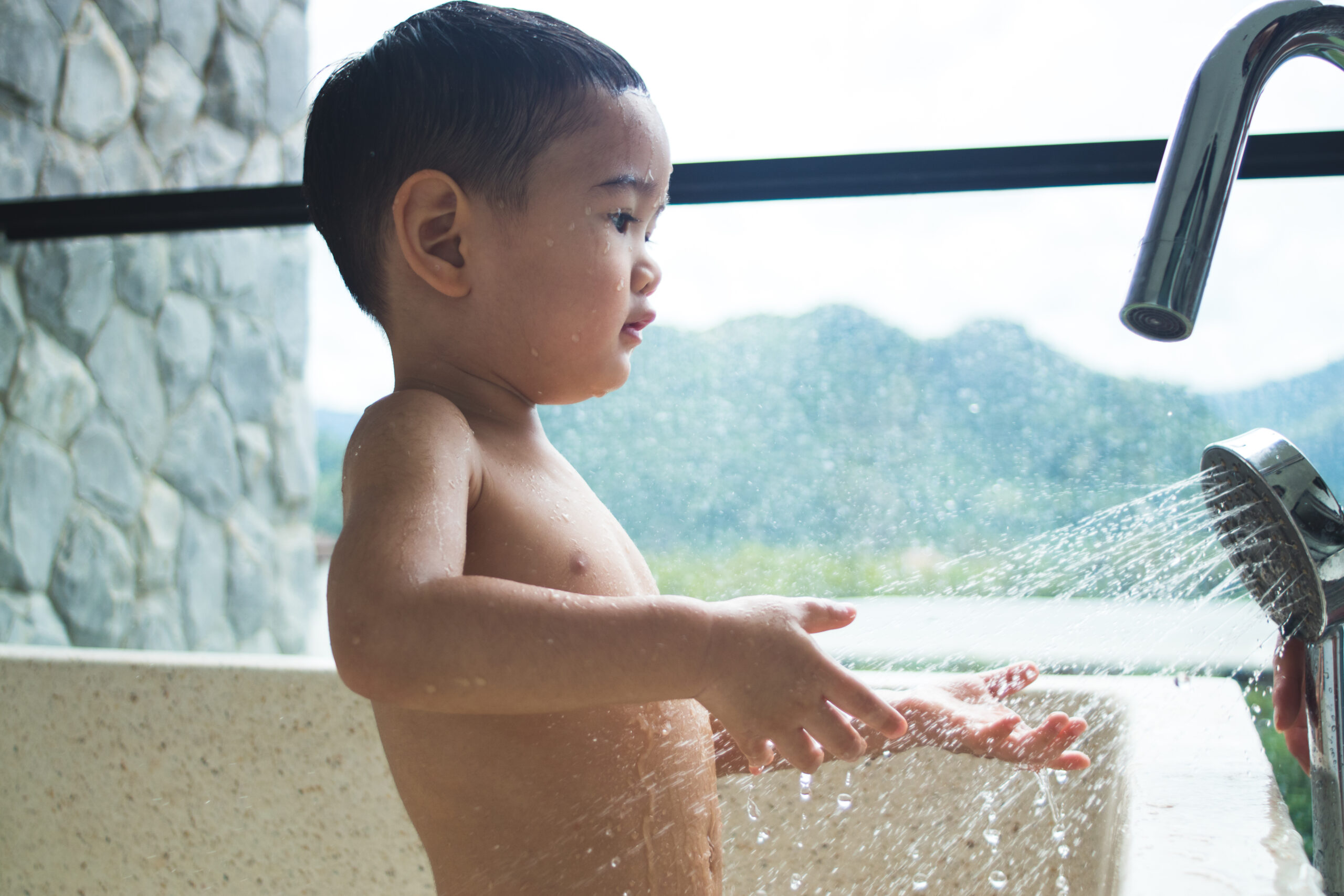 cute-asian-child-bathing-in-the-outdoor-bathroom-2026-01-11-10-39-15-utc