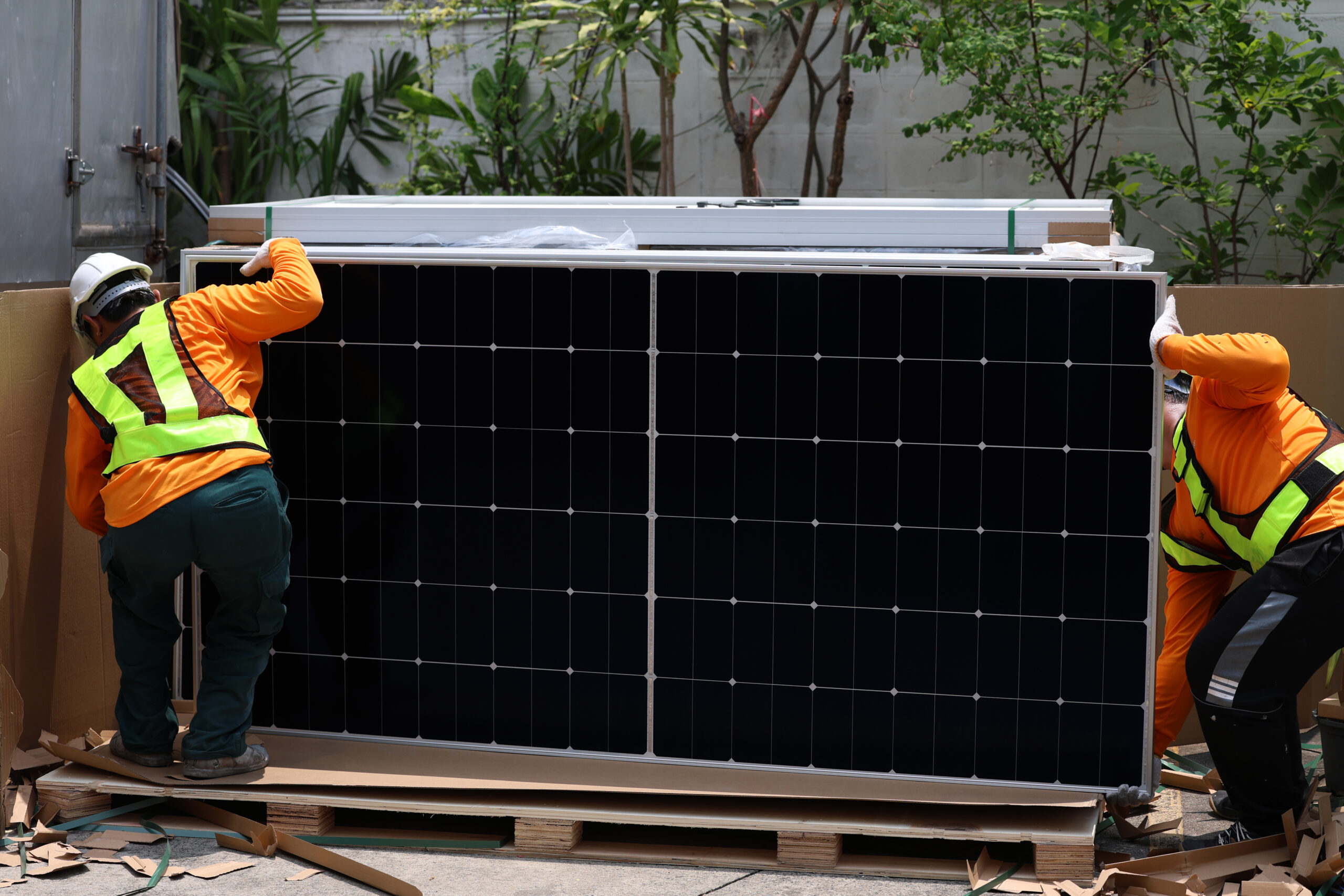 Technicians Install photovoltaic solar modules on roof of house. Engineers install or fix solar cells in roof of house. Technician worker on solar panels. Solar panel technician  working on house roof
